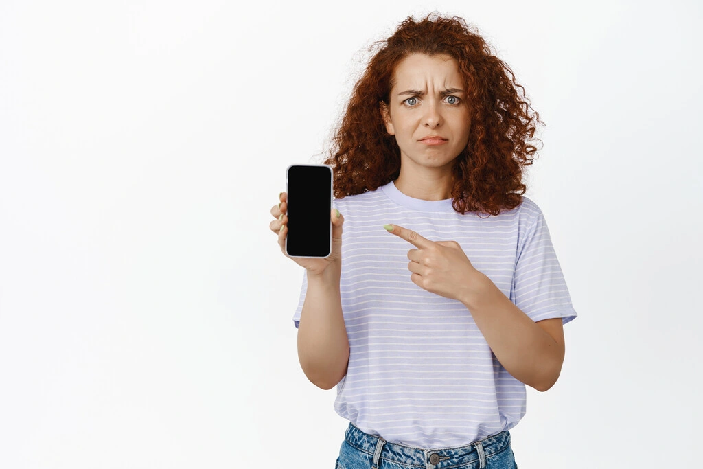 portrait-frowning-disappointed-woman-pointing-mobile-phone-screen-attractive-young-female-model-showing-smth-concerning-disappointing-app-smartphone_Easy-Resize.com
